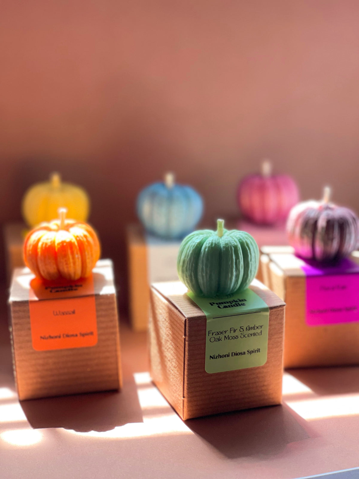 Mini pumpkin candles displayed with cozy autumn and Halloween-inspired decor